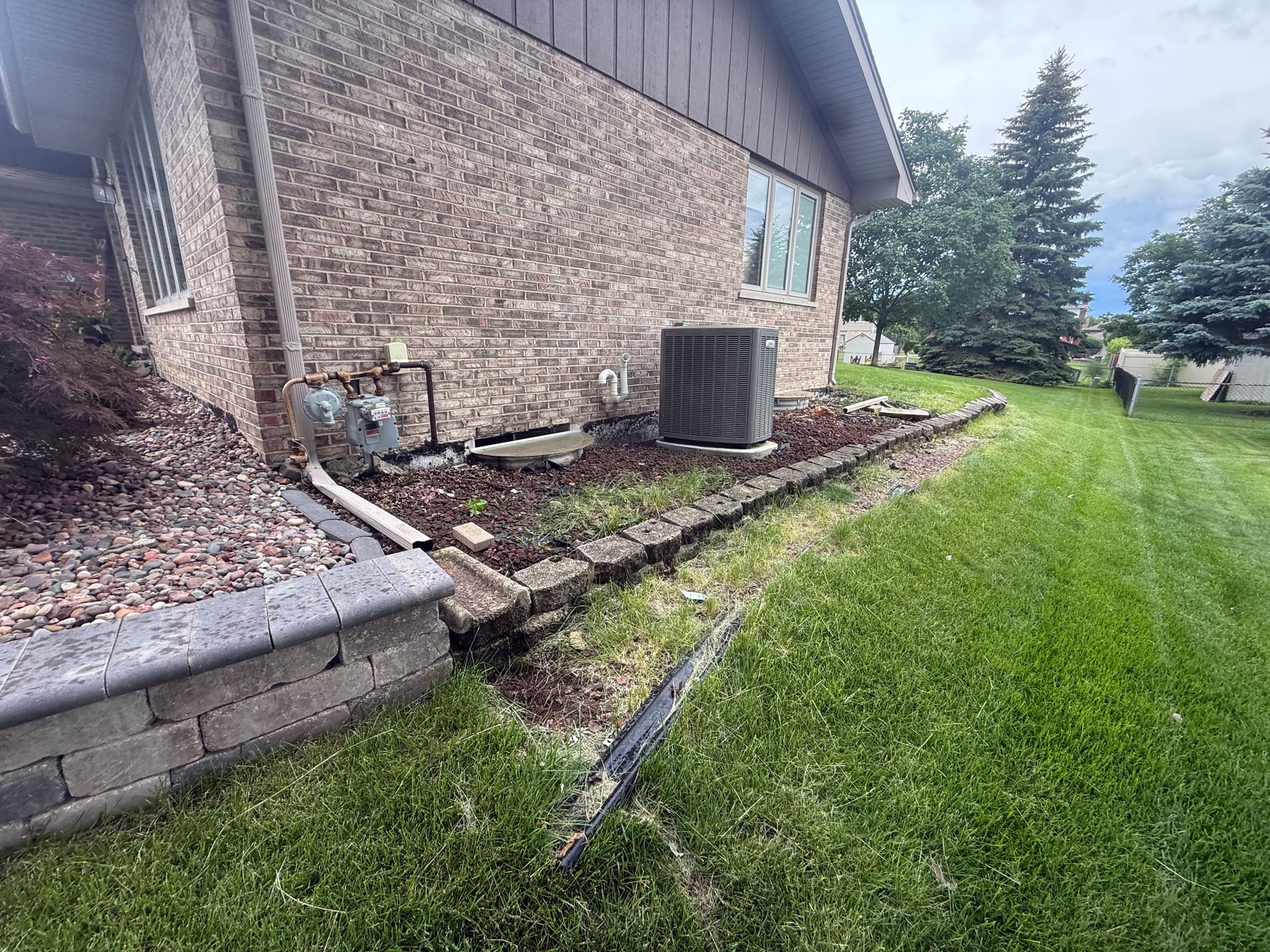 Gallery photos for Retaining Wall Rebuild Fixes a Crumbling Side Yard in Frankfort: Image #1